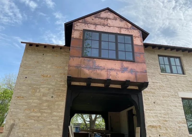 Copper metal panel facade on a stone building for Metal Roof Coating in Lake Wisconsin